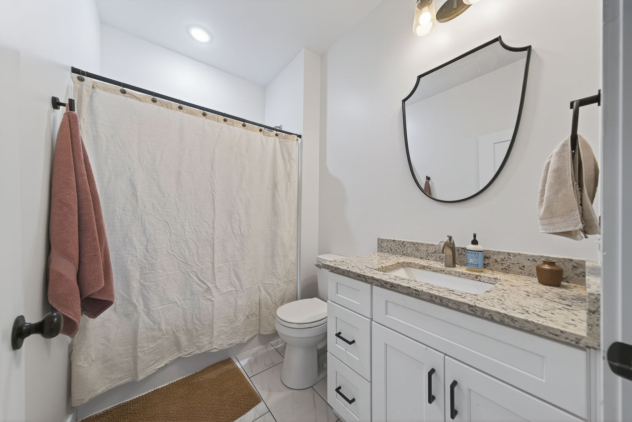 652 Clog Valley Road Sparta, TN 38583 - Photo 19 of 38 a bathroom with a granite countertop sink a toilet and a mirror