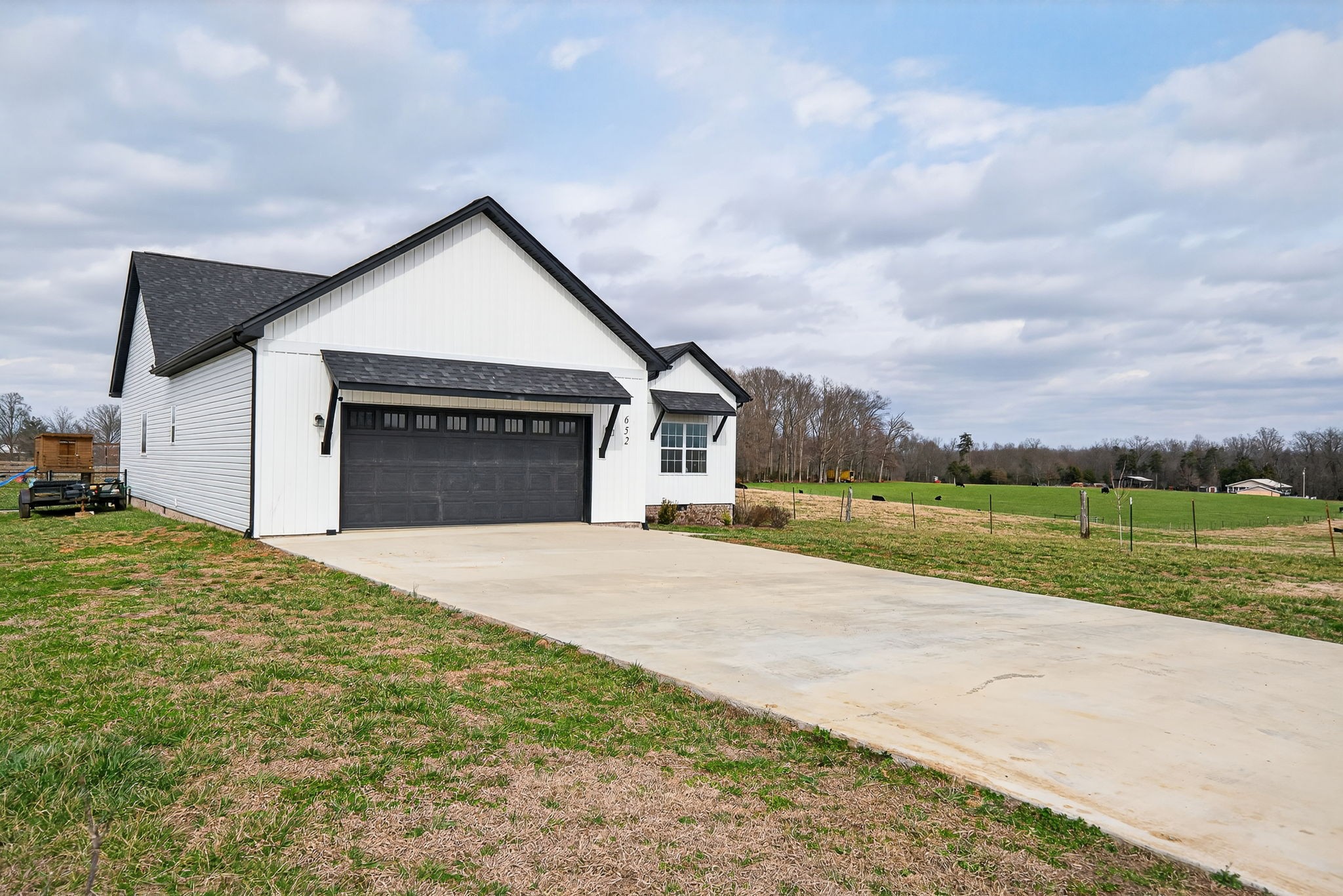 652 Clog Valley Road Sparta, TN 38583 - Photo 33 of 38 a front view of a house with a yard and garage