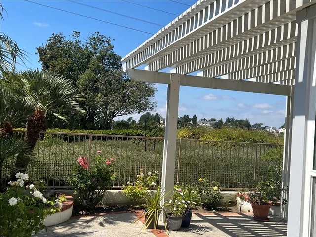 a view of a patio with a table chairs and a umbrella