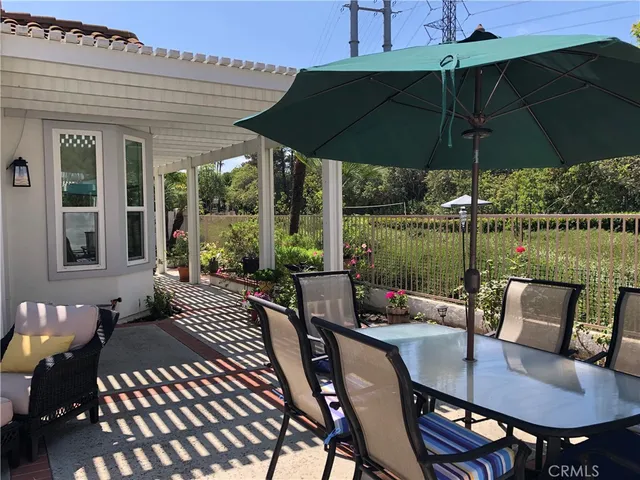 a view of a balcony with chairs and potted plants