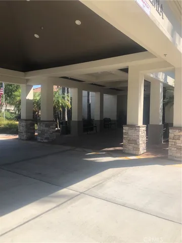 a living room with furniture and a book shelf