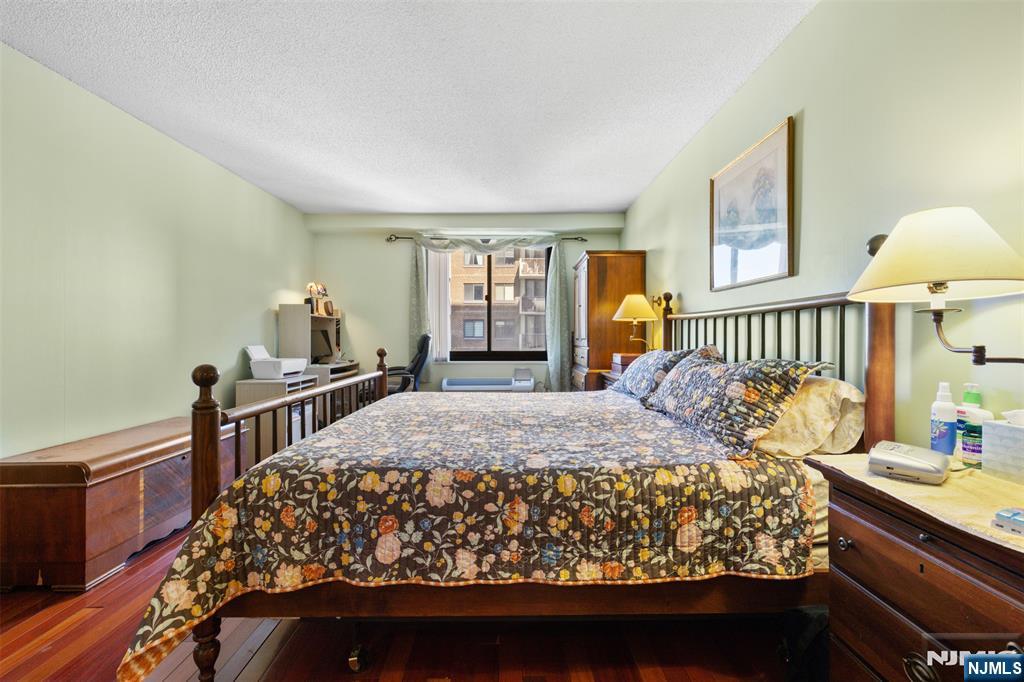 151 Prospect Avenue, Unit 9D Hackensack, NJ 07601 - Photo 15 of 38 a bed sitting in a bedroom next to a window