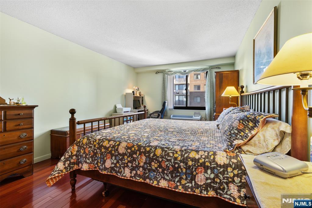 151 Prospect Avenue, Unit 9D Hackensack, NJ 07601 - Photo 16 of 38 a bed sitting in a bedroom next to a window