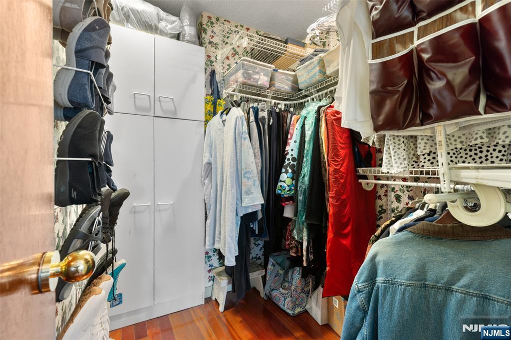 151 Prospect Avenue, Unit 9D Hackensack, NJ 07601 - Photo 20 of 38 a view of walk in closet with clothes