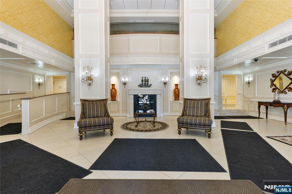 151 Prospect Avenue, Unit 9D Hackensack, NJ 07601 - Photo 31 of 38 a living room with furniture and a fireplace