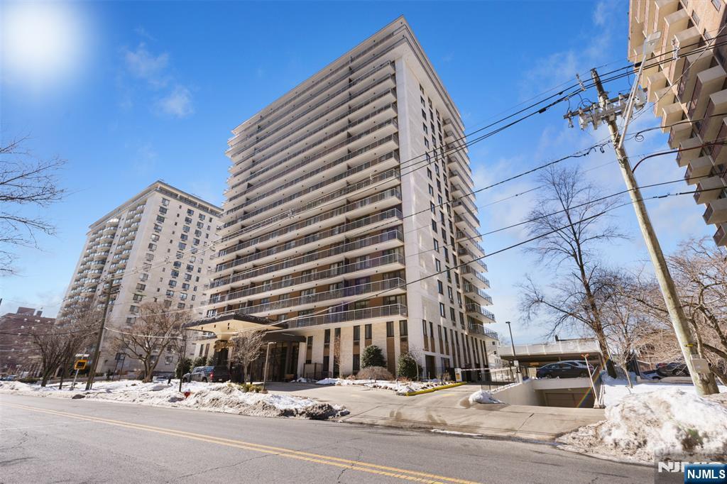 151 Prospect Avenue, Unit 9D Hackensack, NJ 07601 - Photo 34 of 38 a view of a building with a snow on the road