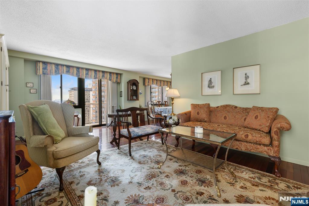 151 Prospect Avenue, Unit 9D Hackensack, NJ 07601 - Photo 4 of 38 a living room with furniture and a large window