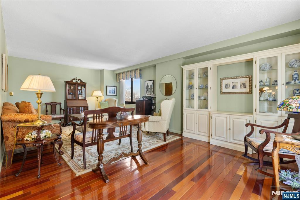 151 Prospect Avenue, Unit 9D Hackensack, NJ 07601 - Photo 5 of 38 a view of a livingroom with furniture a rug wooden floor and windows