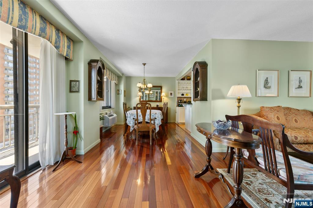 151 Prospect Avenue, Unit 9D Hackensack, NJ 07601 - Photo 6 of 38 a living room with furniture a wooden floor and a large window