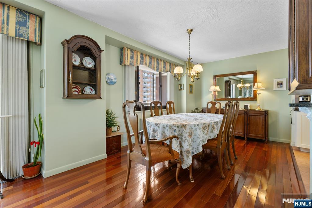 151 Prospect Avenue, Unit 9D Hackensack, NJ 07601 - Photo 7 of 38 a view of a dining room with furniture window and wooden floor