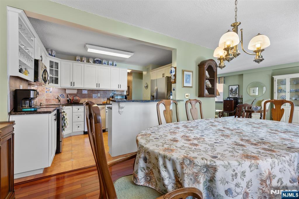 151 Prospect Avenue, Unit 9D Hackensack, NJ 07601 - Photo 9 of 38 a view of a kitchen and dining room