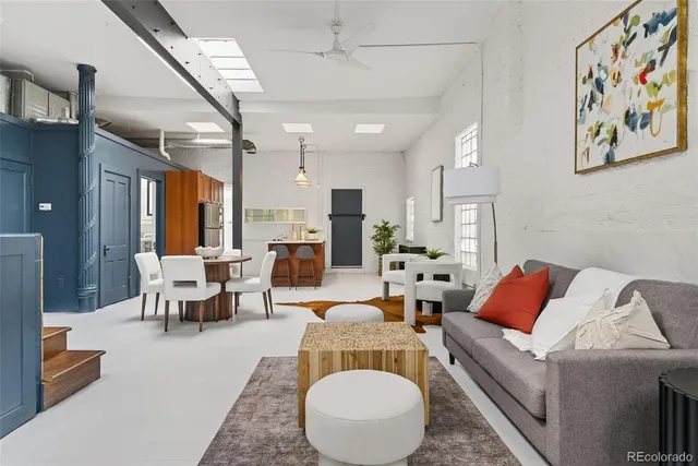 a living room with furniture or couch and a potted plant