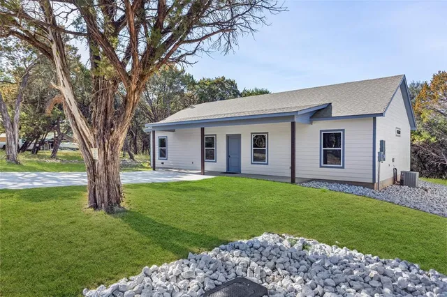 a view of a house with a backyard