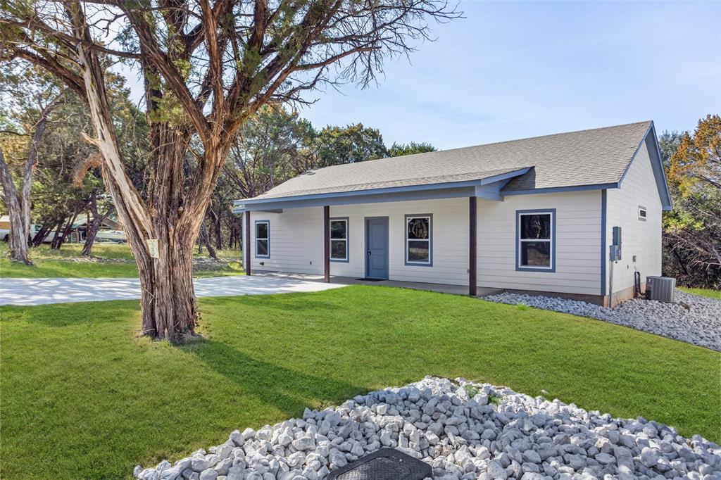 a view of a house with a backyard