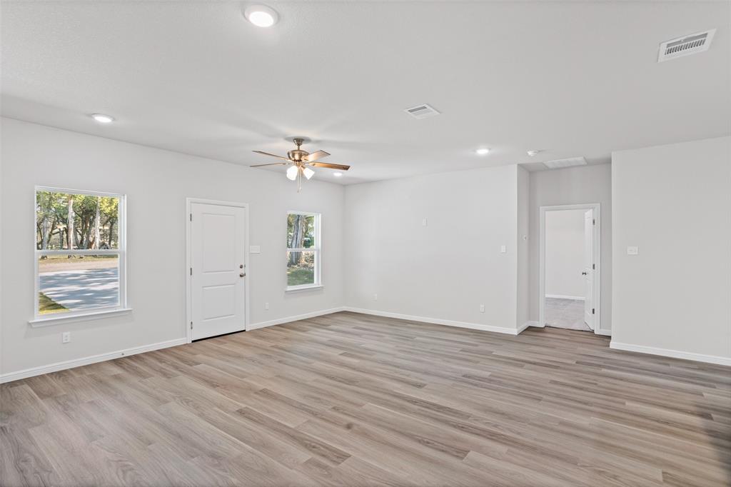 9320 Apache Trail Rio Vista, TX 76093 - Photo 15 of 33 a view of an empty room with wooden floor and a window