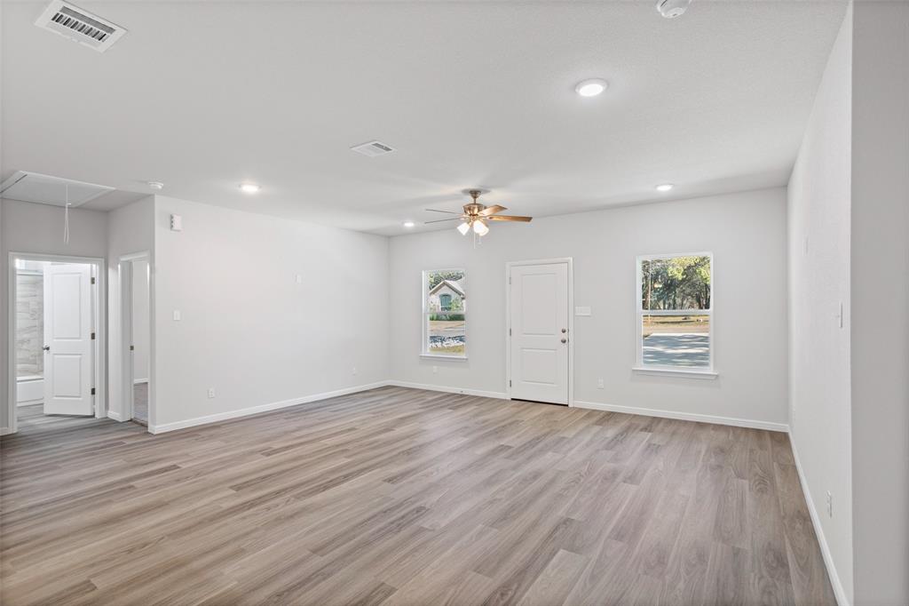 9320 Apache Trail Rio Vista, TX 76093 - Photo 16 of 33 wooden floor in an empty room with a window