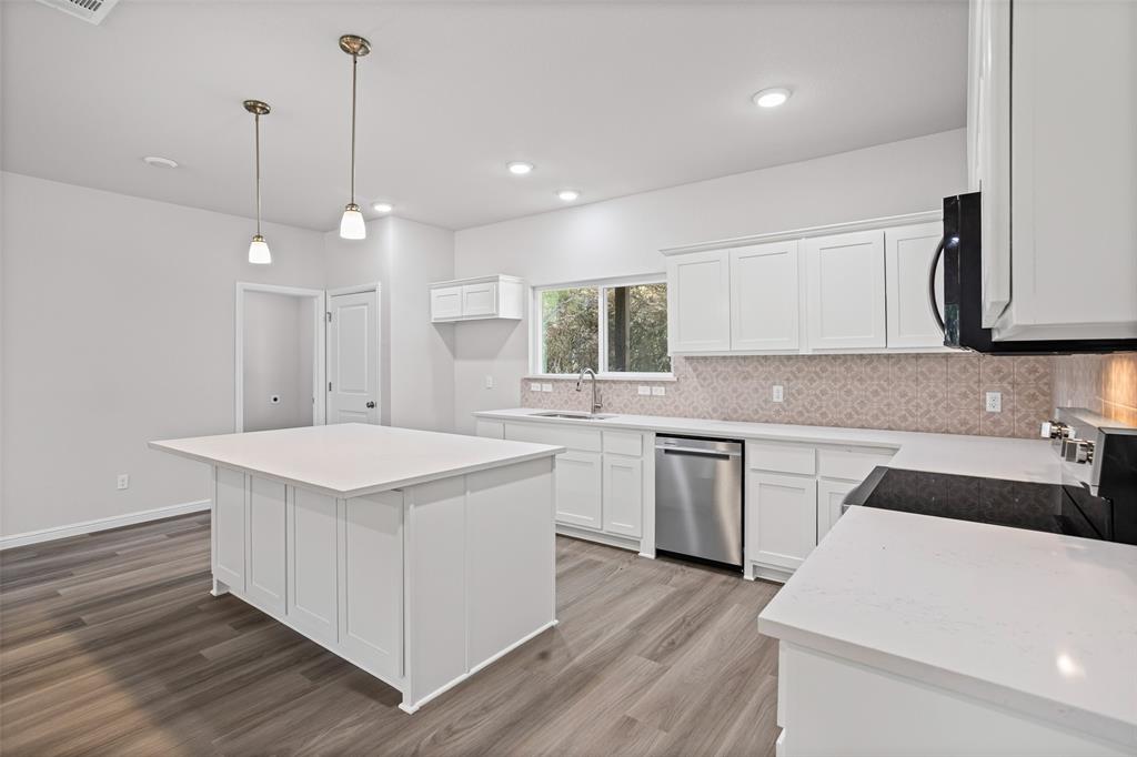 9320 Apache Trail Rio Vista, TX 76093 - Photo 18 of 33 a kitchen with a sink a stove a refrigerator and white cabinets