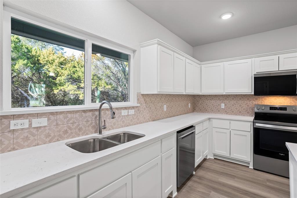 9320 Apache Trail Rio Vista, TX 76093 - Photo 19 of 33 a kitchen with a sink cabinets and window