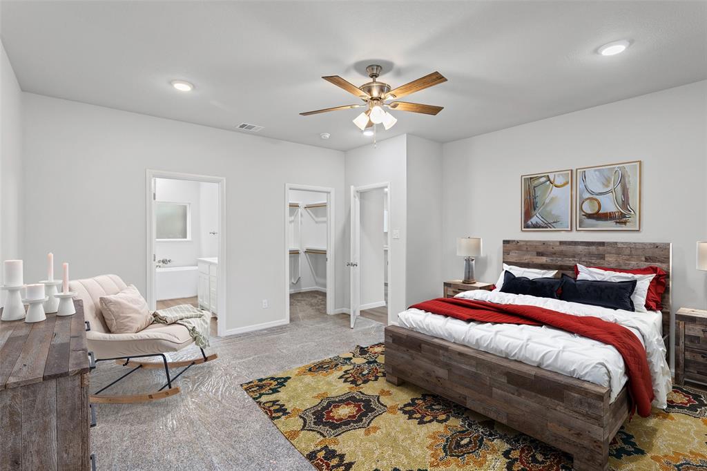 9320 Apache Trail Rio Vista, TX 76093 - Photo 23 of 33 a bedroom with a bed and a chandelier