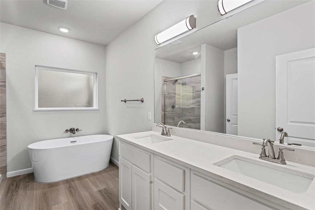 9320 Apache Trail Rio Vista, TX 76093 - Photo 24 of 33 a bathroom with a double vanity sink and a mirror