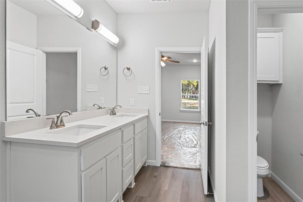 9320 Apache Trail Rio Vista, TX 76093 - Photo 26 of 33 a bathroom with a double vanity sink and mirror
