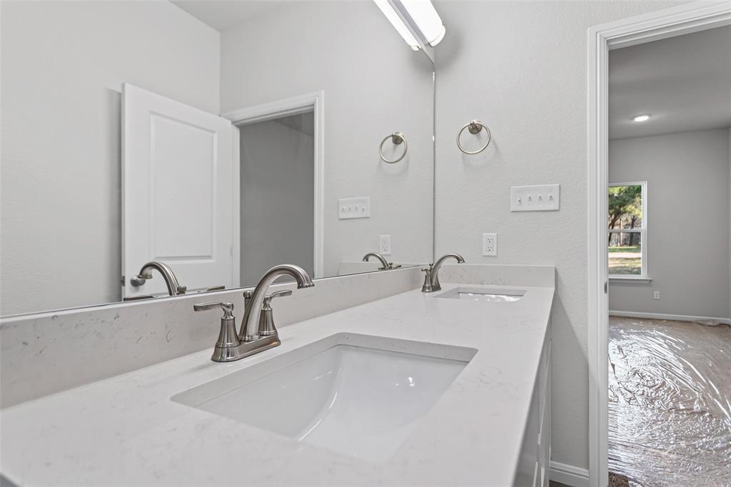 9320 Apache Trail Rio Vista, TX 76093 - Photo 27 of 33 a bathroom with a double vanity sink