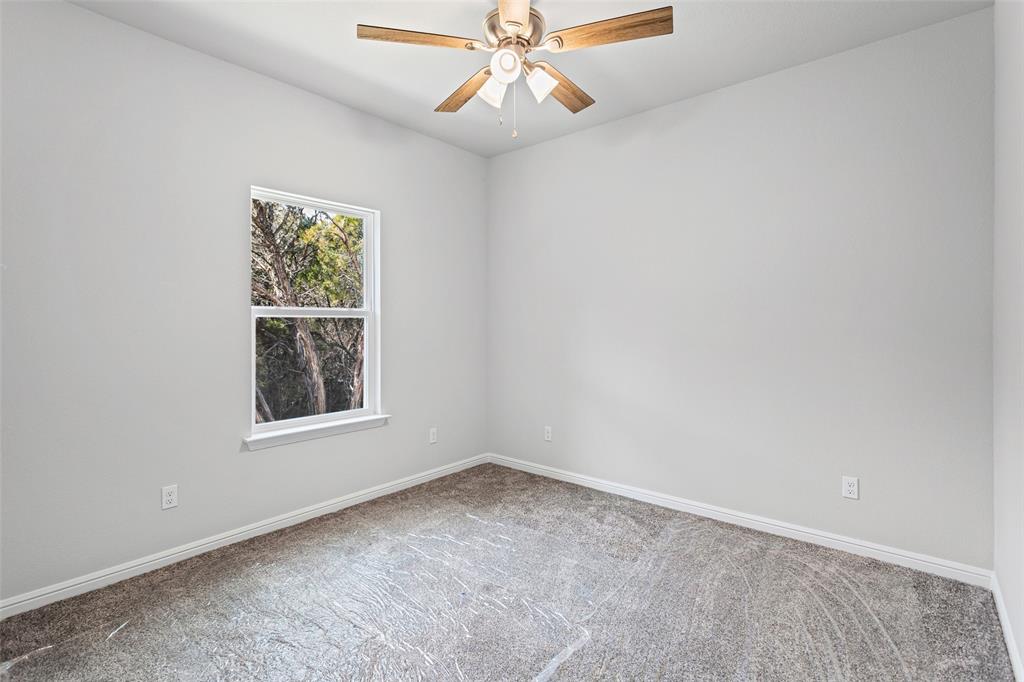 9320 Apache Trail Rio Vista, TX 76093 - Photo 32 of 33 an empty room with a window and a fan