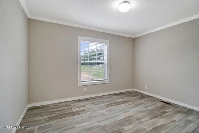 wooden floor in an empty room with a window
