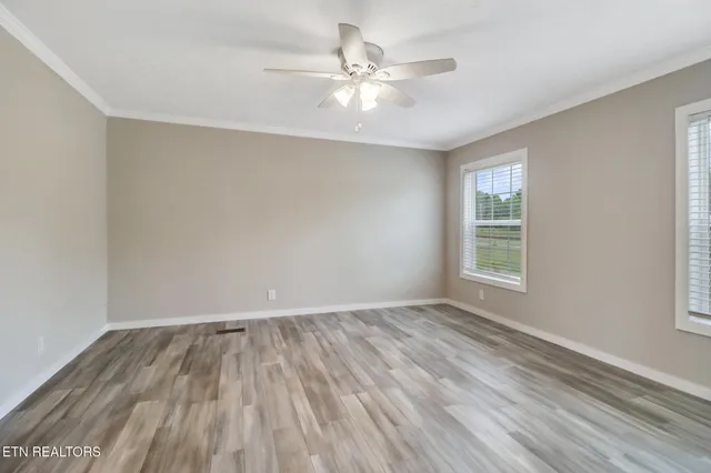 wooden floor in an empty room with a window