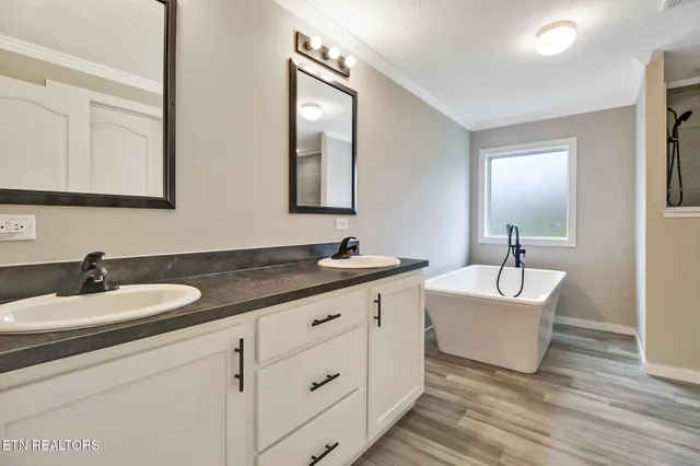 a en suite bathroom with a double vanity sink and a mirror