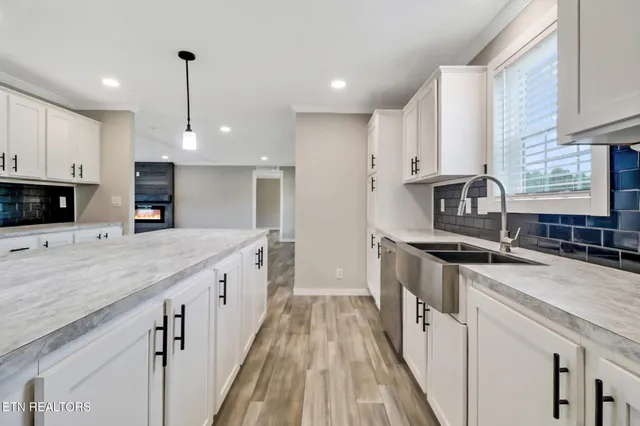 a kitchen with stainless steel appliances granite countertop a sink stove and cabinets