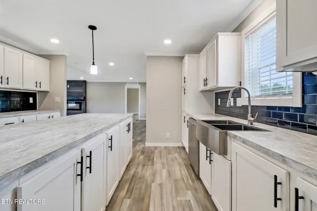 a kitchen with stainless steel appliances granite countertop a sink stove and cabinets