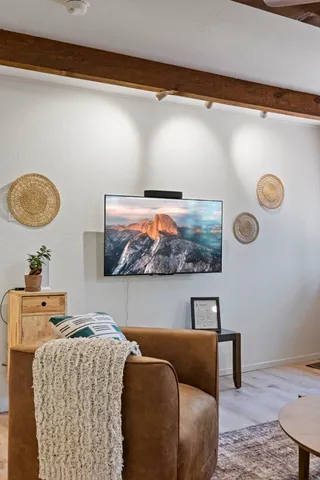 a living room with furniture a fireplace and a large window