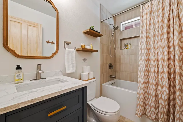 a bedroom with two beds and a chandelier