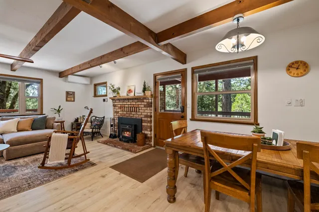 a living room with furniture a fireplace and a large window