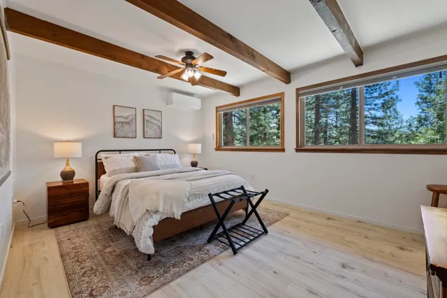 a bedroom with a bed a chandelier and a window