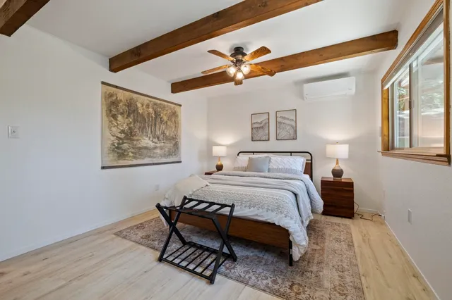 a bedroom with a bed and a painting on the wall