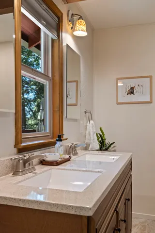 a living room with furniture two window and a fireplace