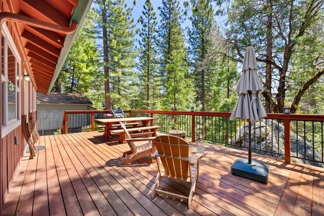 a view of balcony with wooden floor and outdoor seating