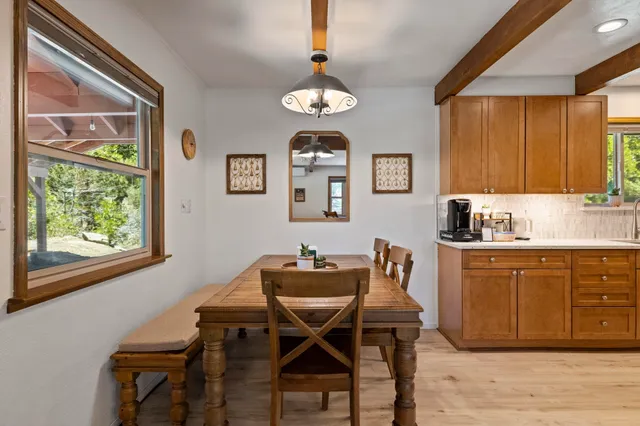 a dining room with wooden floor and a window