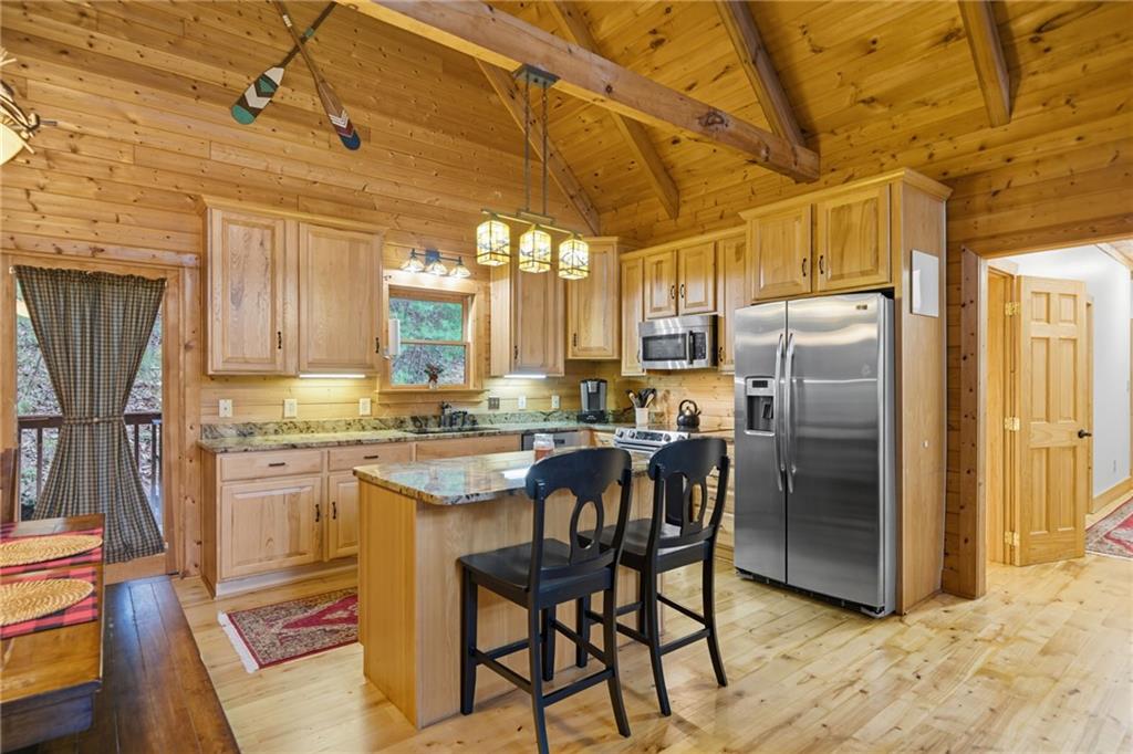 469 Moss Patch Trail Jasper, GA 30143 - Photo 15 of 49 a kitchen with stainless steel appliances granite countertop a refrigerator a stove a sink dishwasher and white cabinets with wooden floor