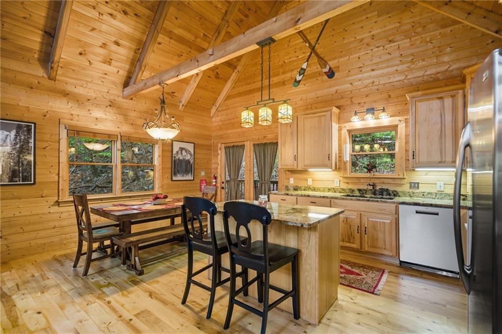 469 Moss Patch Trail Jasper, GA 30143 - Photo 16 of 49 a dining hall with stainless steel appliances granite countertop a dining table and chairs with the wooden floor