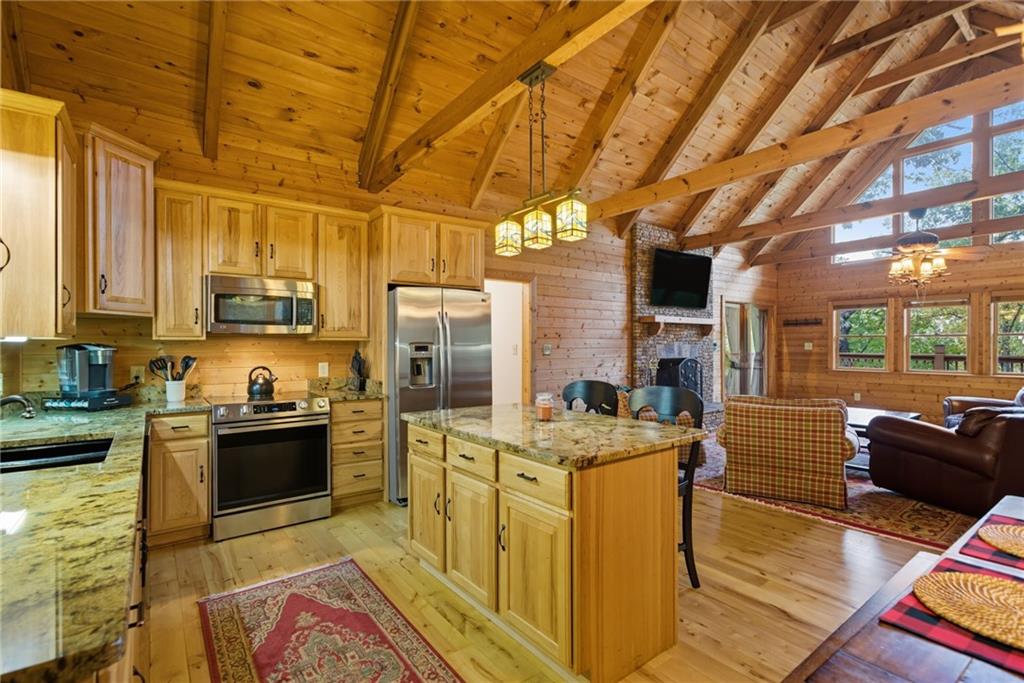 469 Moss Patch Trail Jasper, GA 30143 - Photo 17 of 49 a kitchen with stainless steel appliances kitchen island granite countertop a sink stove and cabinets