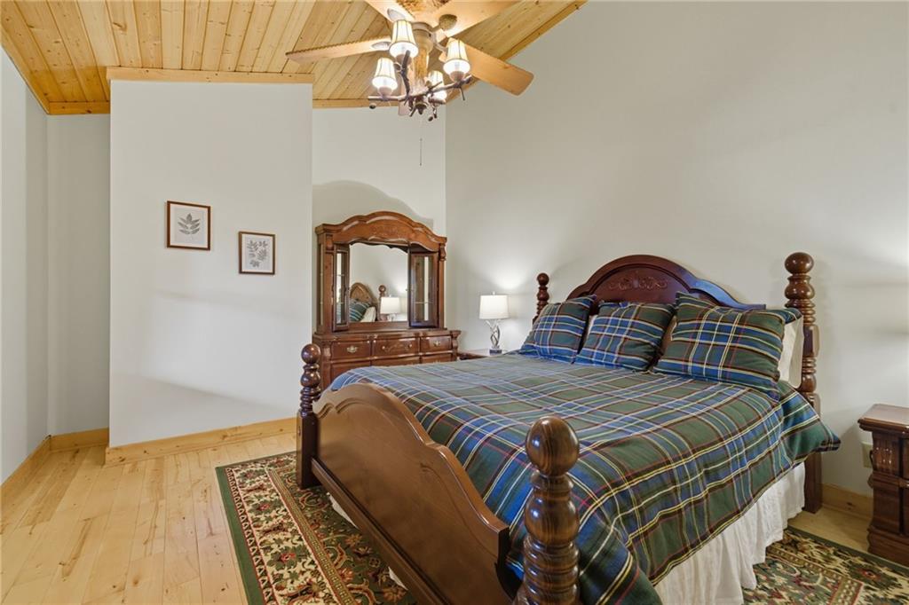 469 Moss Patch Trail Jasper, GA 30143 - Photo 20 of 49 a bedroom with a bed and a chandelier