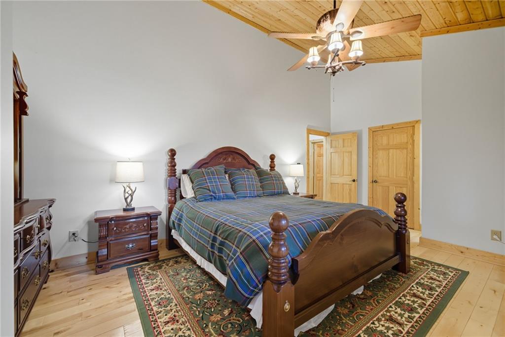 469 Moss Patch Trail Jasper, GA 30143 - Photo 21 of 49 a bedroom with a bed and a chandelier