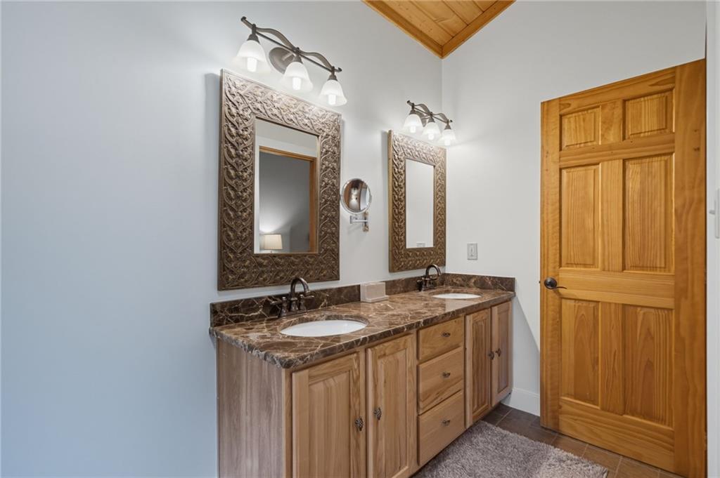 469 Moss Patch Trail Jasper, GA 30143 - Photo 22 of 49 a bathroom with a granite countertop sink and a mirror