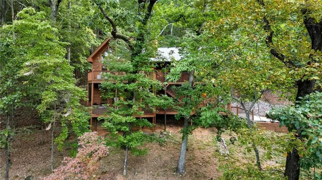 a view of a house with a yard and sitting area