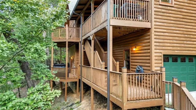 an aerial view of a house with a yard and trees all around