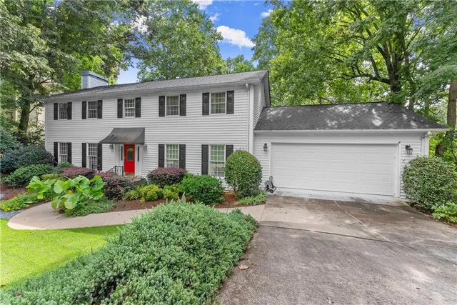 a front view of house with yard and green space