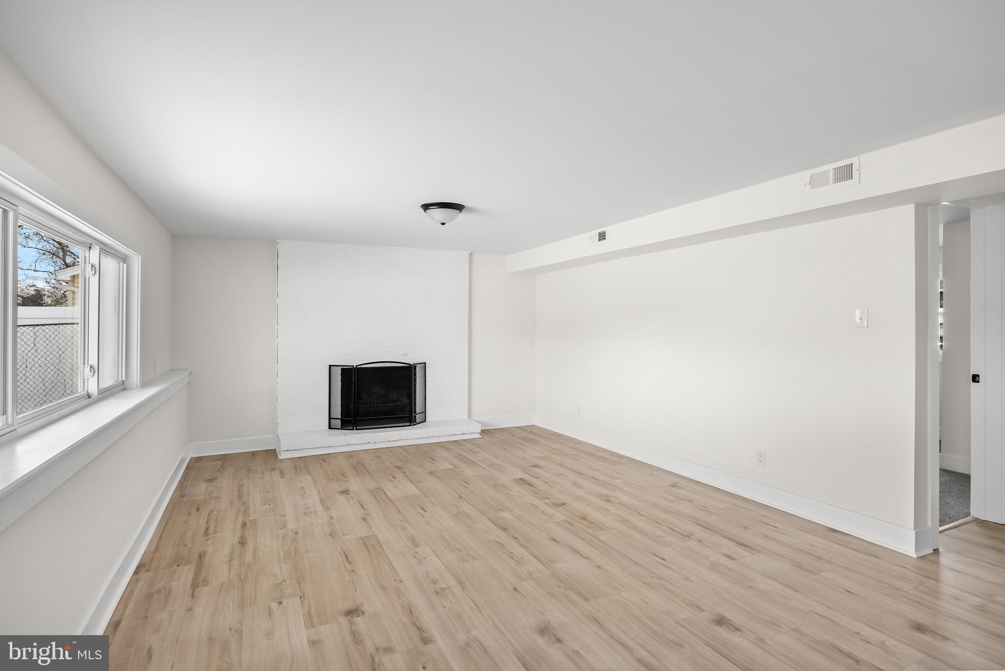 10 Cobblestone Road Cherry Hill, NJ 08003 - Photo 14 of 15 a view of an empty room with wooden floor and a window